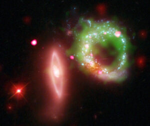 arp147_multi This composite image of Arp 147 shows Chandra X-ray data in pink, Hubble optical data in red, green and blue, ultraviolet GALEX data in green and infrared Spitzer data in red.