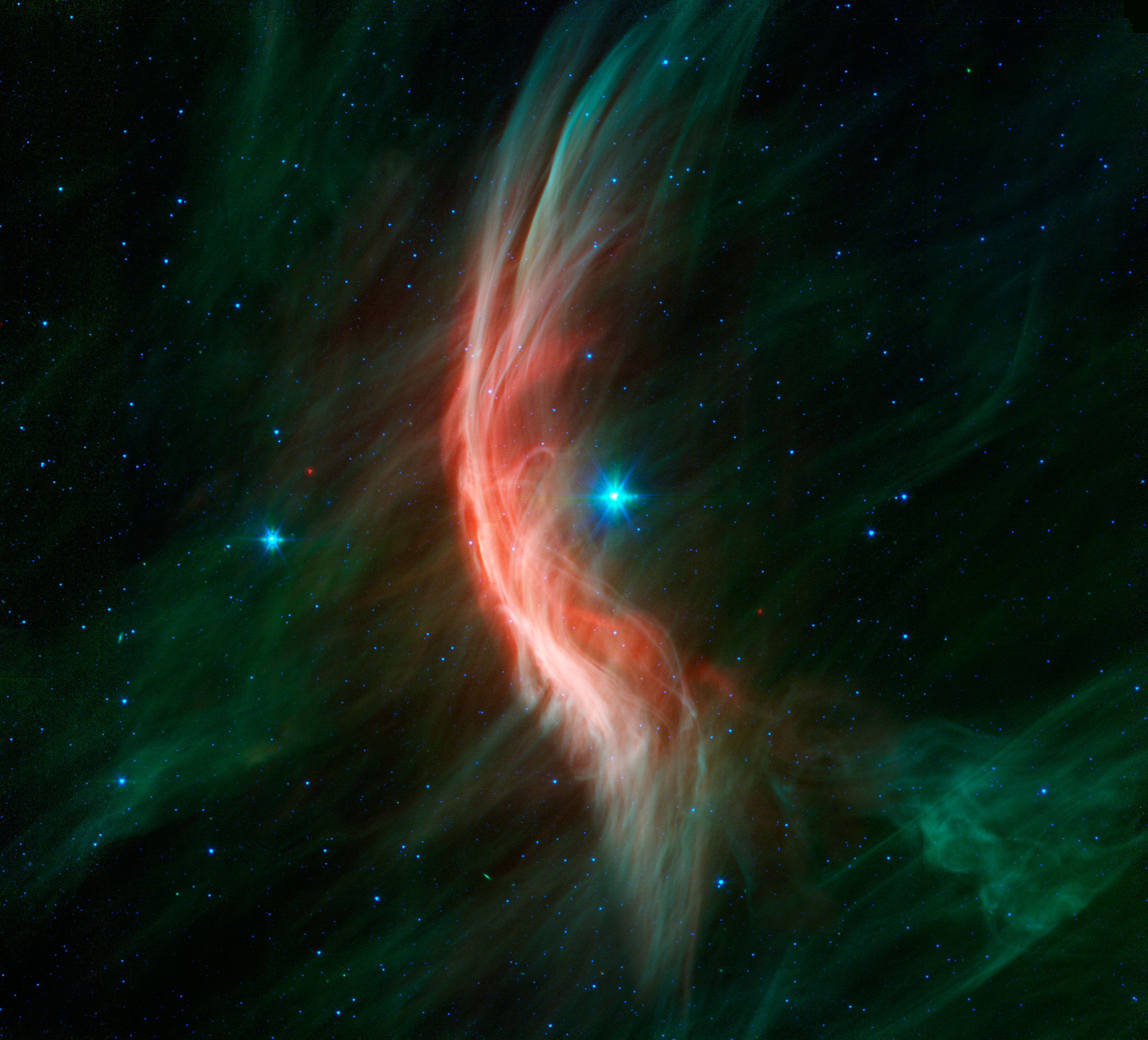 The giant star Zeta Ophiuchi is having a "shocking" effect on the surrounding dust clouds in this infrared image from NASAâs Spitzer Space Telescope. Stellar winds flowing out from this fast-moving star are making ripples in the dust as it approaches, c